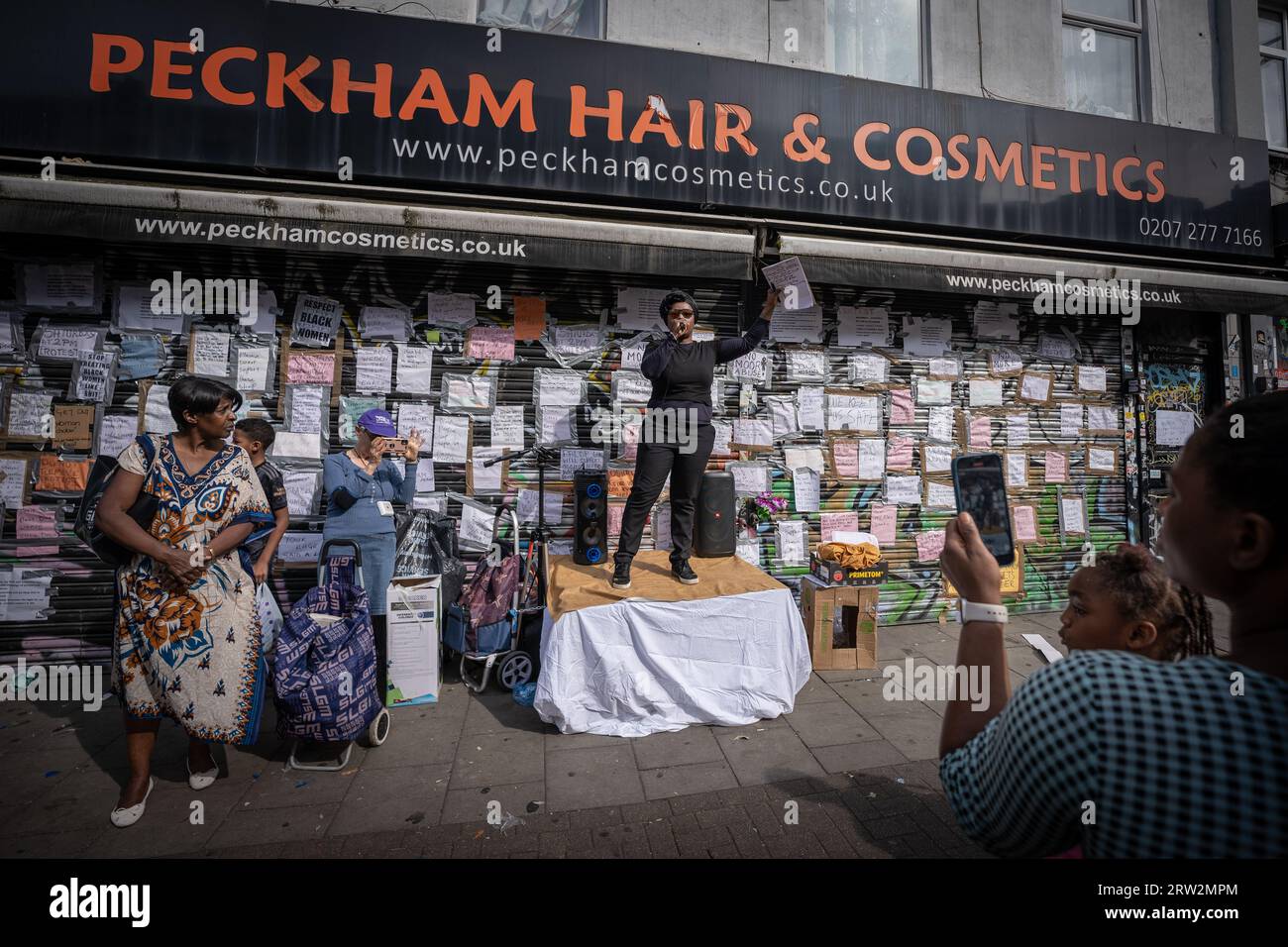 London, UK. 16th September 2023. Protests and speeches continue outside Peckham Hair and Cosmetics shop on Rye Lane in east London. The south east London hair and beauty shop has remained closed since Tuesday 12th after a video circulated on social media appears to show a scuffle between a 31-year old black woman and the male owner of Peckham Hair and Cosmetics, Sohail Sindho, 45, who appears to put his hands around her throat during the altercation. Credit: Guy Corbishley/Alamy Live News Stock Photo