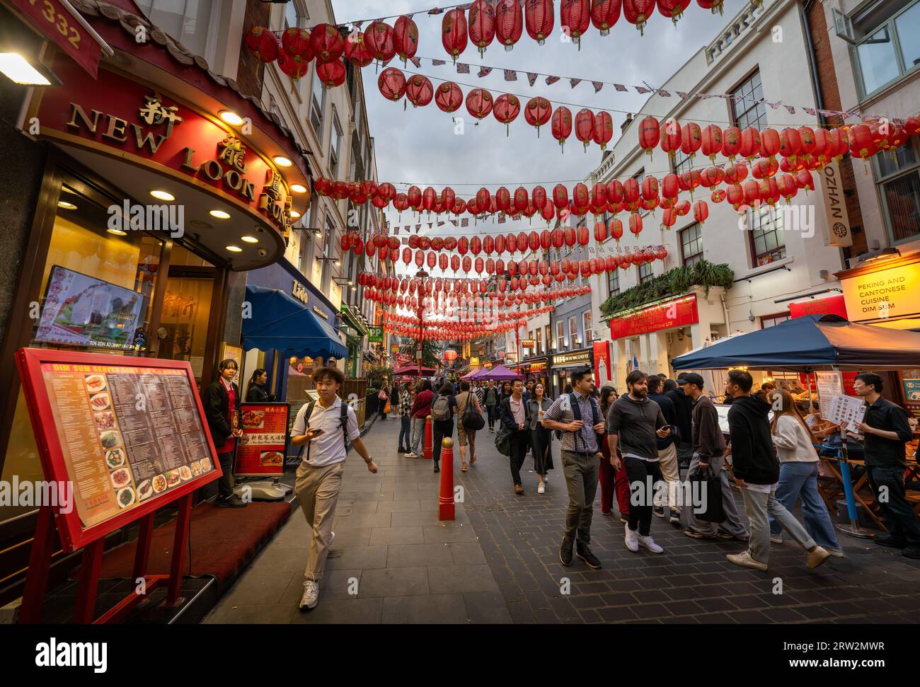 London, UK: Gerard Street in London's Chinatown. Tourist street in central London with Chinese restaurants and red Chinese lanterns. Stock Photo