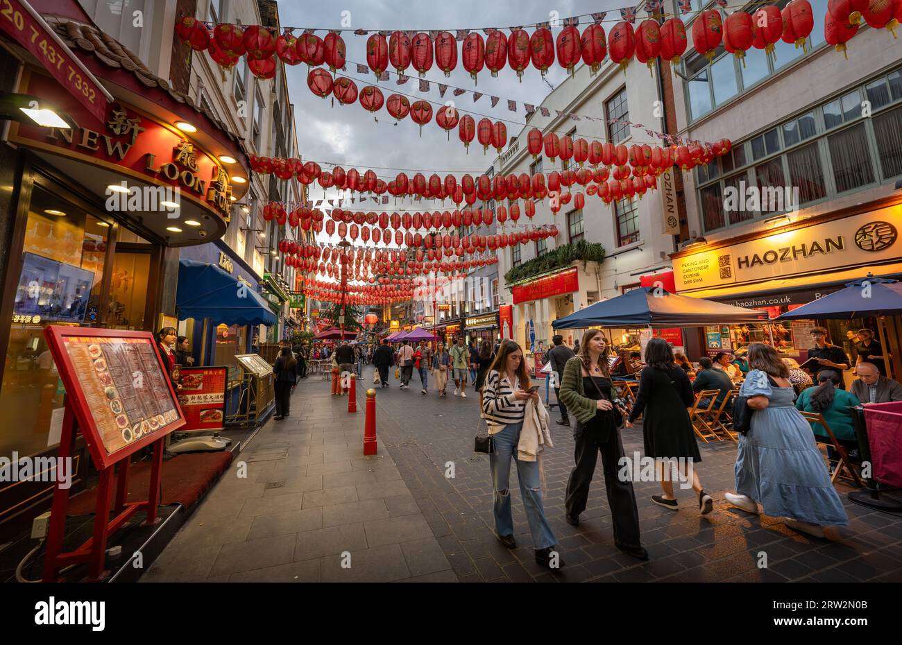 London, UK: Gerard Street in London's Chinatown. Tourist street in central London with Chinese restaurants and red Chinese lanterns. Stock Photo