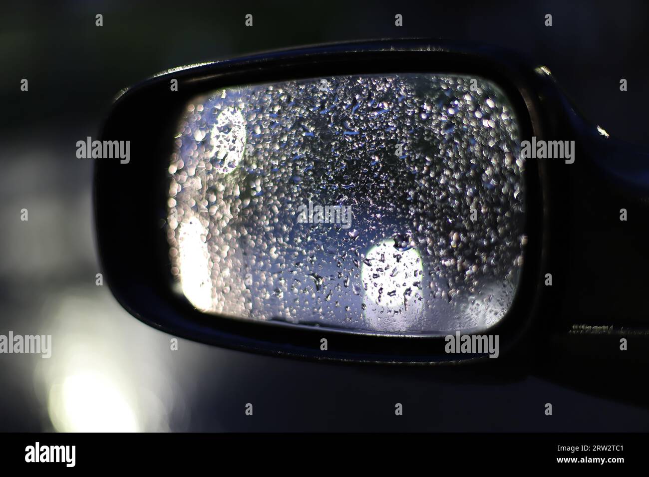 Raindrops on the rearview mirror of the car Stock Photo