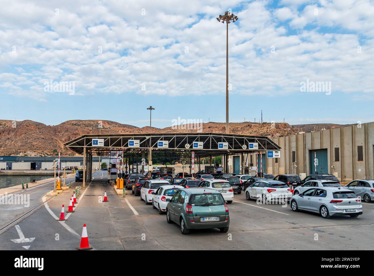 Passenger cars in the port of Almería after disembarking from a Moroccan ferry and waiting to pass customs control to access the European Community. Stock Photo