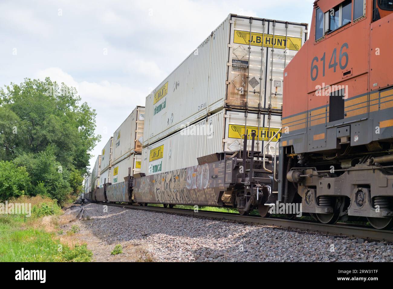 Oregon, Illinois, USA. A Burlington Northern Santa Fe Railway intermodal freight train after exiting a bridge portal while crossing a river. Stock Photo