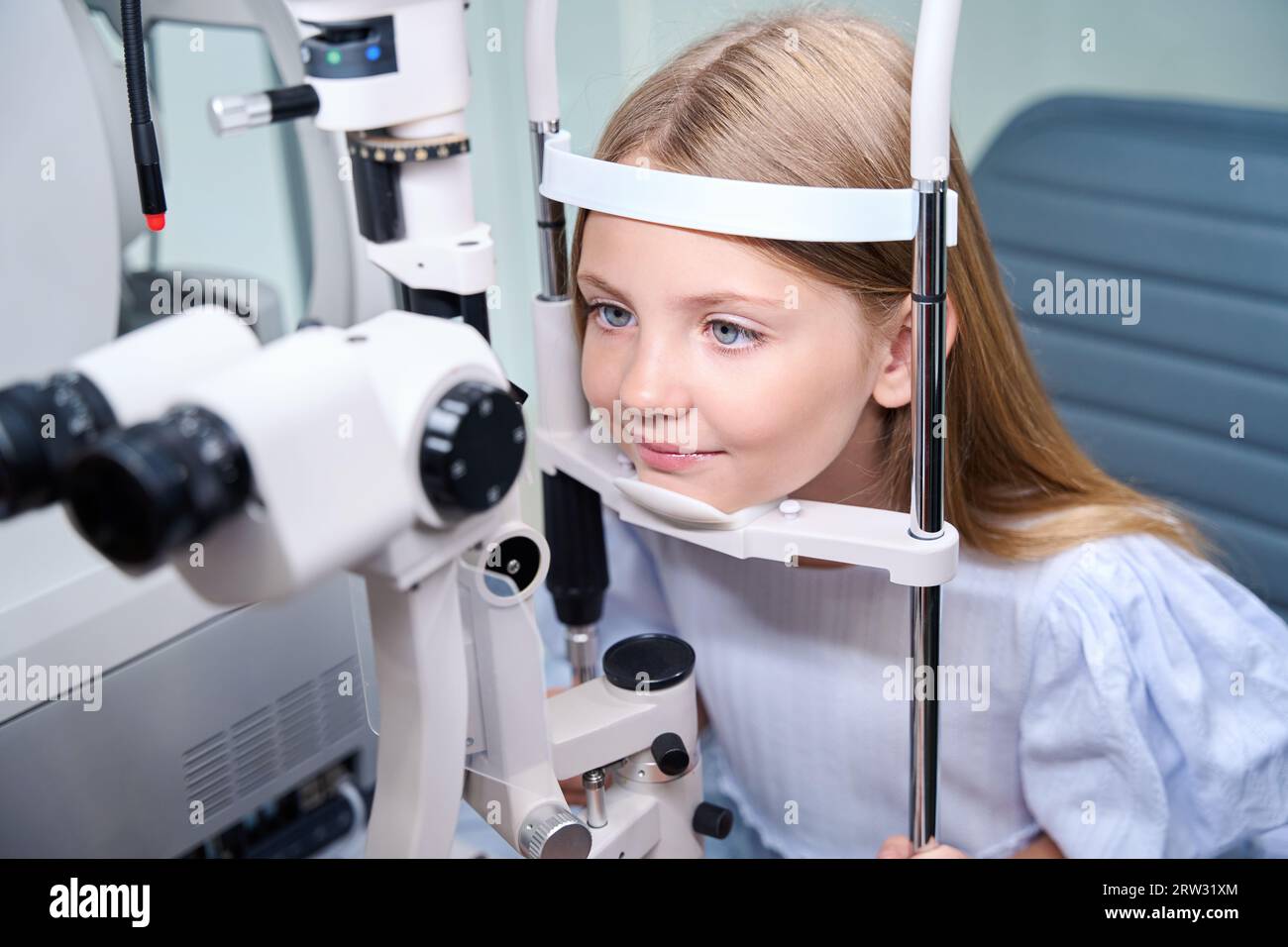 Little patient undergoing eye exam at ophthalmology clinic Stock Photo