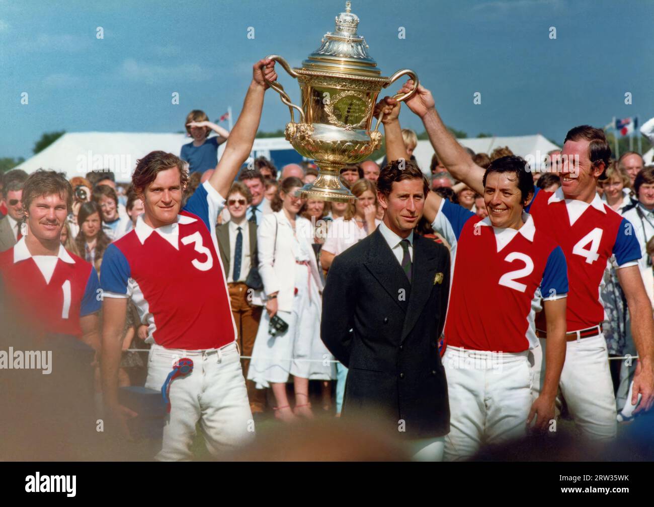 Prince Charles presenting the Coronation Cup to the winners.The Rest of the World 6, England 5.   Prince Charles presents The Coronation Cup to Antonia Herrers, (WEARING NO 2 on his shirt) the  Mexican captain of the Rest of the World team .Rest of the World Team shirt numbers .No1 J Sieder (6) No  2 A Herrers(9) No 3 Crotto  No 4 (Back) J McKay (7)  ENGLAND No 1 J Horswell (6) No 2 J Hipwood (8) No 3 P Withers (8) Back No 4 H Hipwood (8)  ....... Took place at (1980) Guards Polo Club ,Smiths Lawn ,Windsor Great Park Photo has been restored using  AI ,Topaz Pho AI Stock Photo
