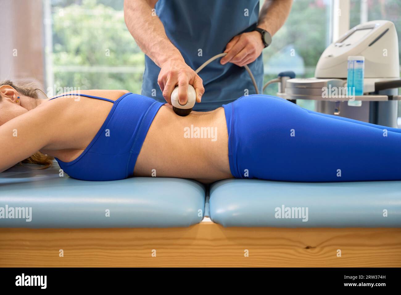 Physiotherapist keeping magnetotherapy procedure in his office Stock Photo