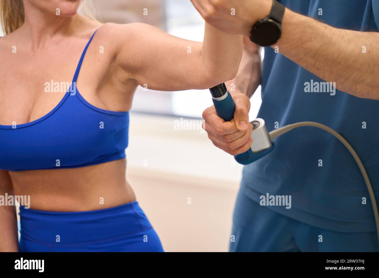 Rehabilitation specialist keeping trigger point massage on woman patient forearm Stock Photo