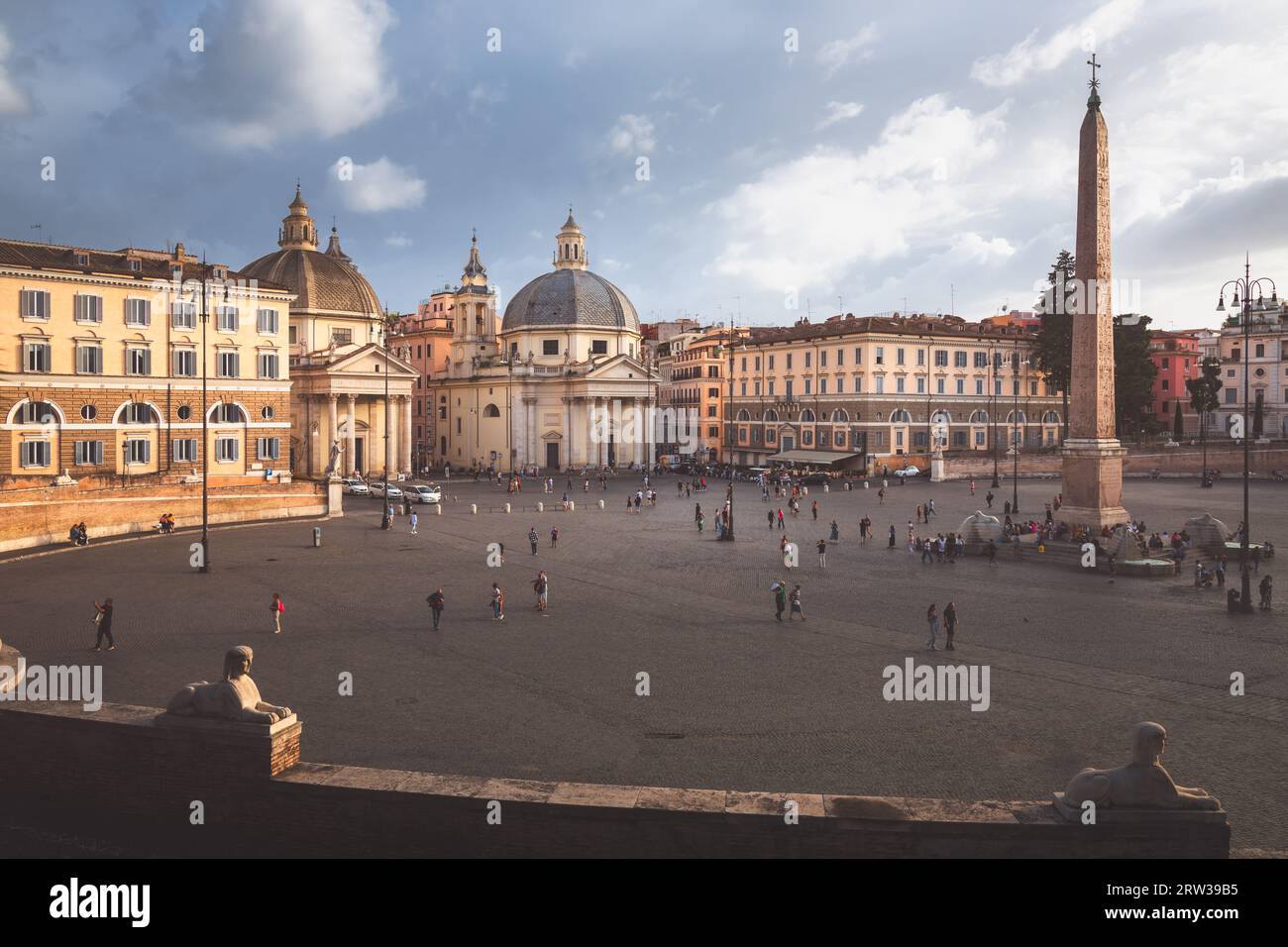Rome, Italy - August 28, 2023: Moody, atmospheric cityscape view over Baroque churches and obelisk in the popular tourist landmark Piazza del Popolo i Stock Photo