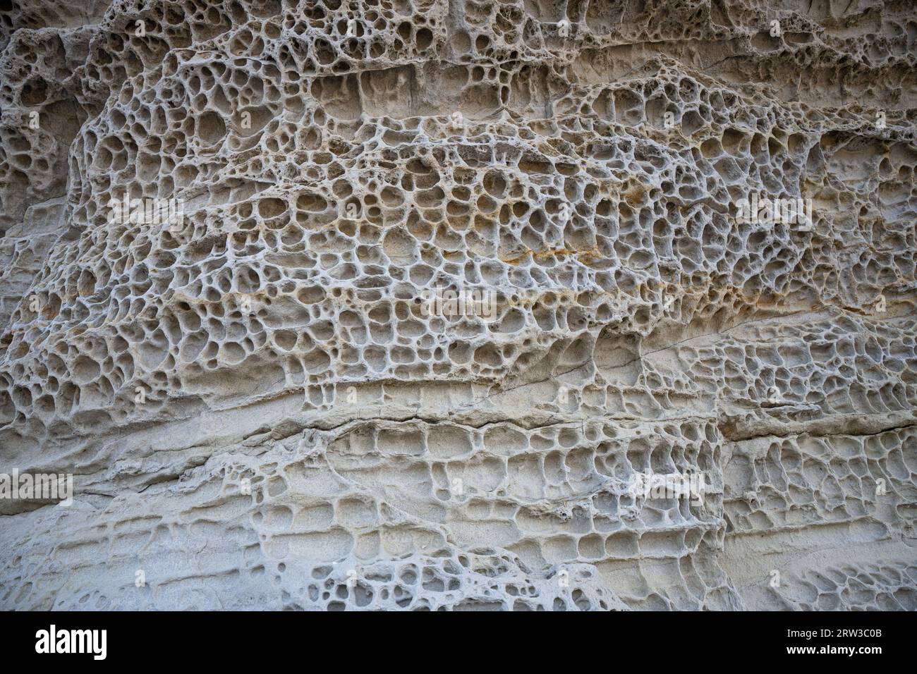 Elgol Beach Isle of Skye Scotland.  Honeycomb Rock.  The weathering is caused by erosion from the sea and salt. Stock Photo