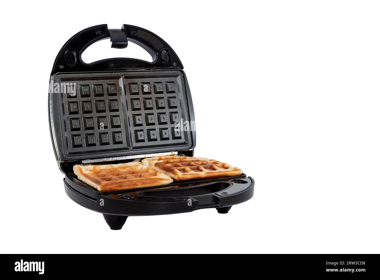 Waffles in an electric waffle iron on a white background. Homemade
