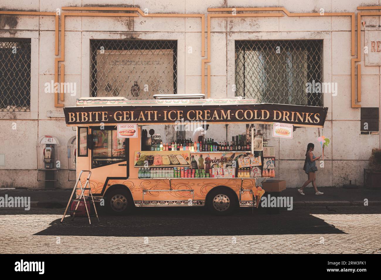 Rome, Italy - August 27, 2023: Urban scene of a street vendor selling snacks and refreshments in the historic old town of central Rome outside of the Stock Photo