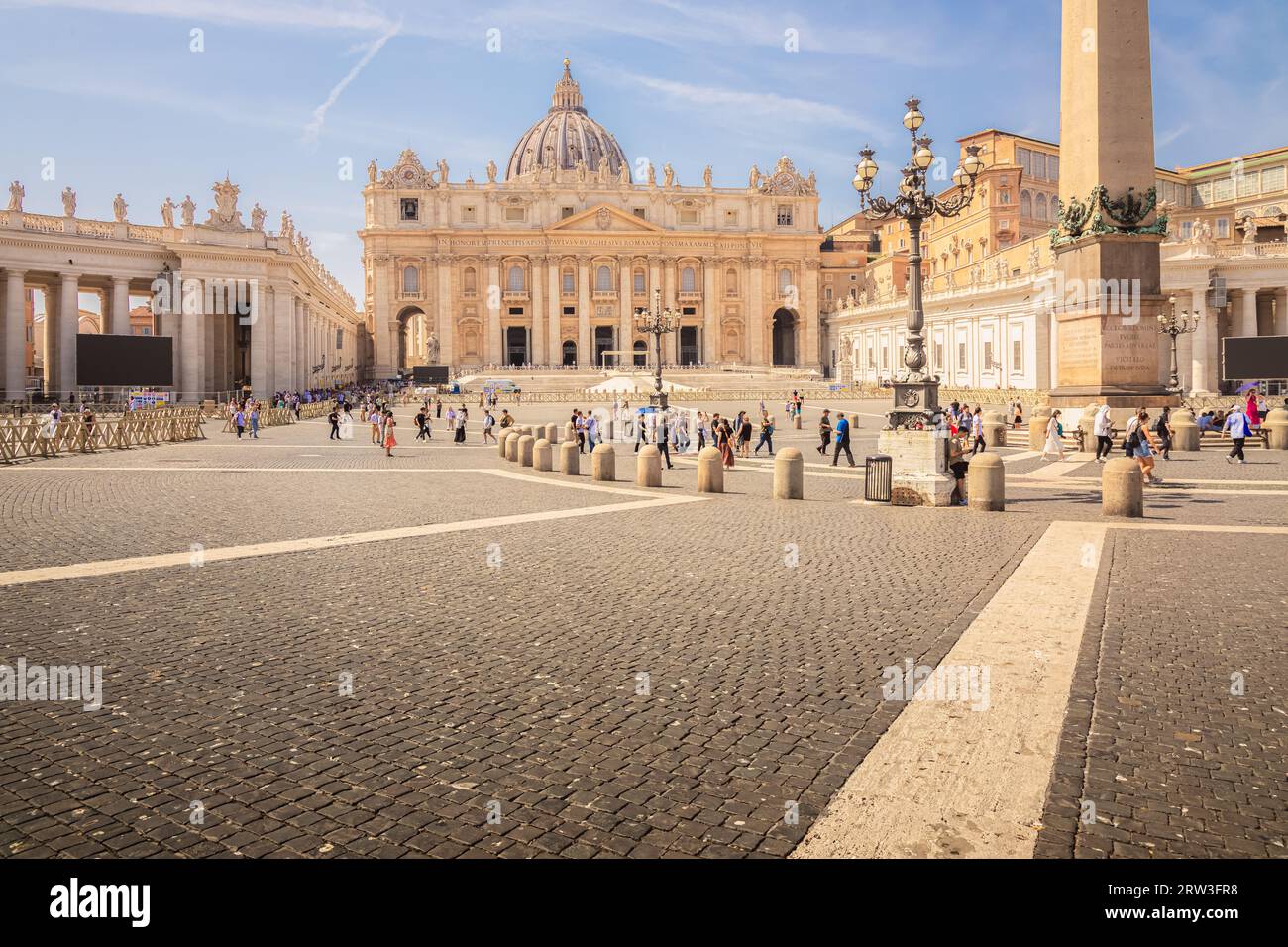 Vatican City - August 27, 2023: Tourists visit the historic Saint Peter's Square and basilica at the Vatican, home of the Roman Catholic Church, on a Stock Photo