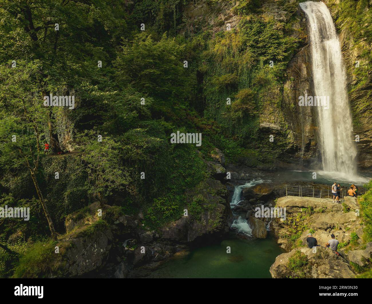 Aerial view of a majestic waterfall cascading down a lush, tropical ...