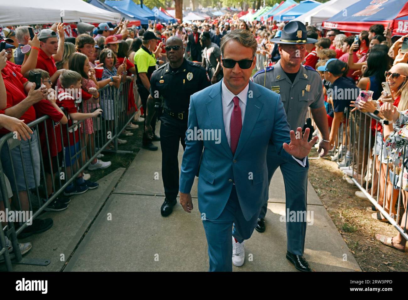 Mississippi head coach Lane Kiffin waves to fans during the Walk of