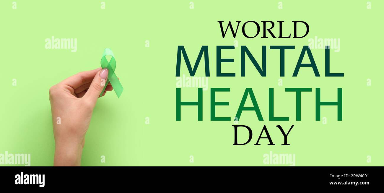 Banner for World Mental Health Day with hand holding green awareness ...
