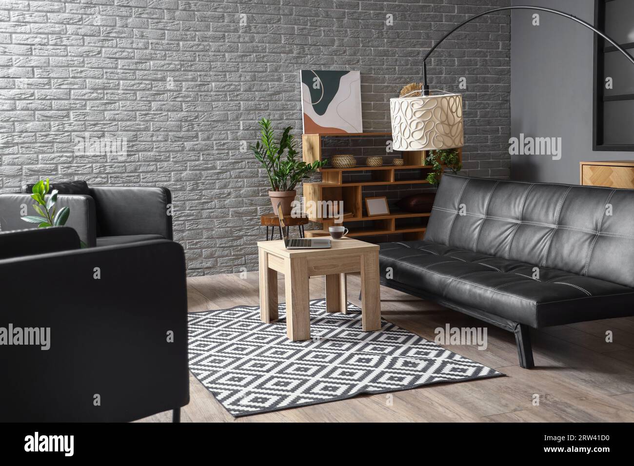 Interior of modern living room with black couch and table Stock Photo ...