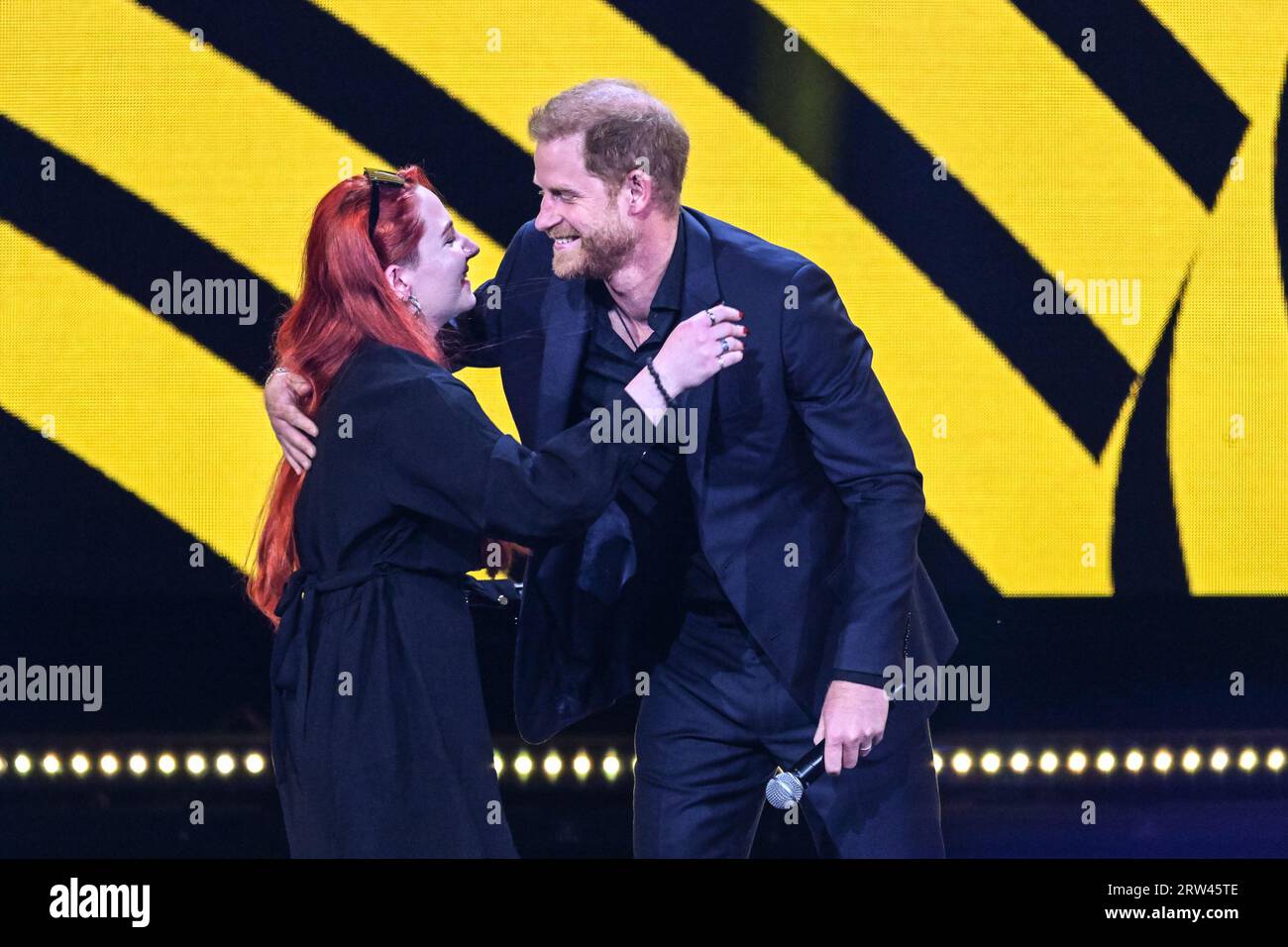 Düsseldorf, Germany. 16th Sep, 2023. Prince Harry, the Duke of Sussex hugs Anna-Sofia Puzanova,daughter of captured Ukrainian paramedic and athlete Yulia Paievska, at the closing ceremony.The Invictus Games Düsseldorf conclude with a closing ceremony at Merkur Spiel Arena. 21 nations participated in the games this year. Athletes parade around the arena and participate, and there are performances from singers Sam Ryder and Rita Ora, as well as speeches from Prince Harry, German President Steinmeyer and other dignitaries. Credit: Imageplotter/Alamy Live News Stock Photo
