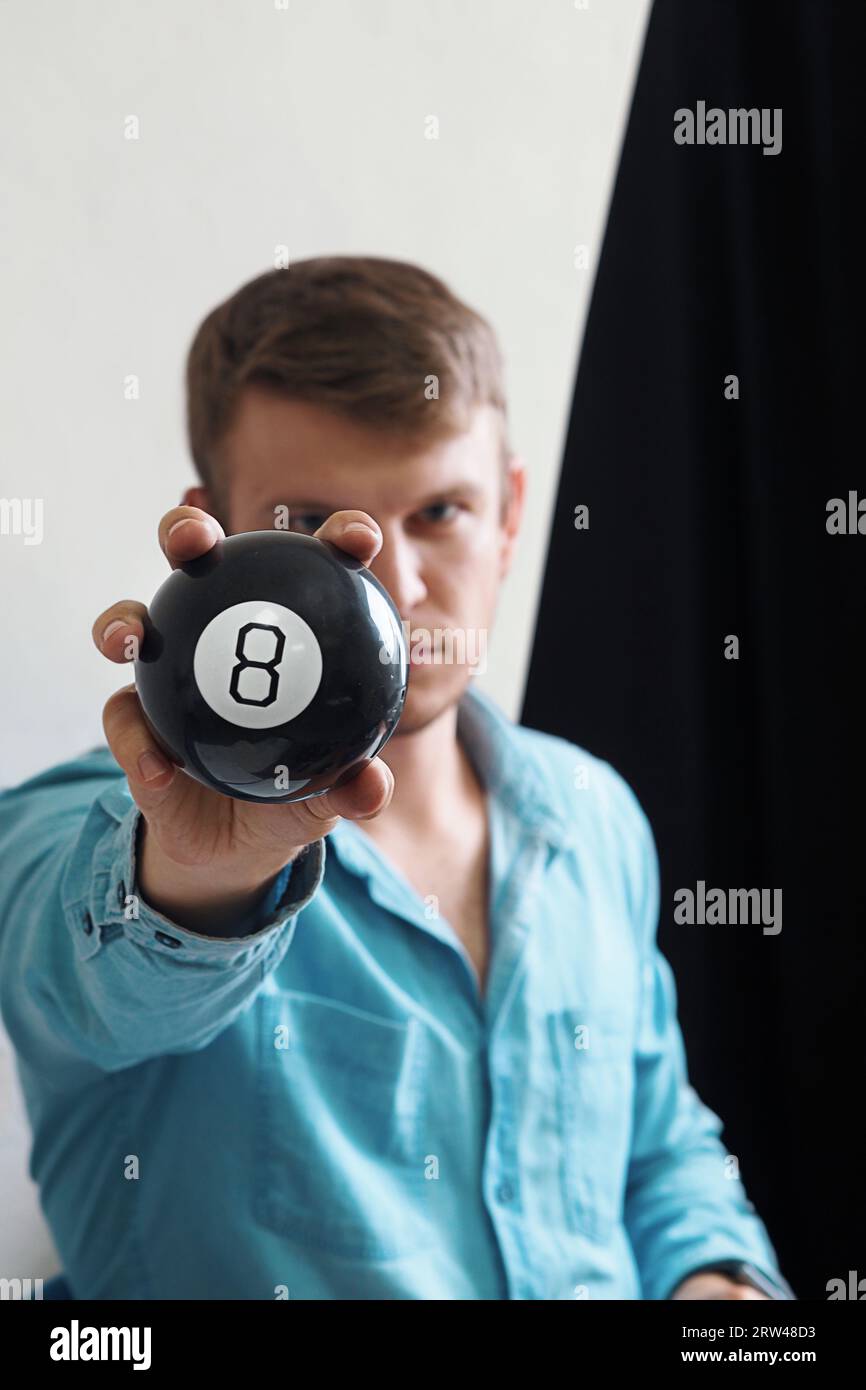 Man shows ball with number to camera. Lucky number or winning lottery