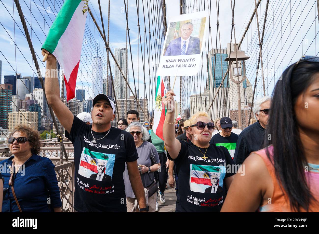 Hundreds of people rally and march across of Brooklyn Bridge in New York on September 16, 2023  on one year anniversary of murder of Mahsa Jina Amini in Iran after arest for allegedly not wearing the hijab Stock Photo