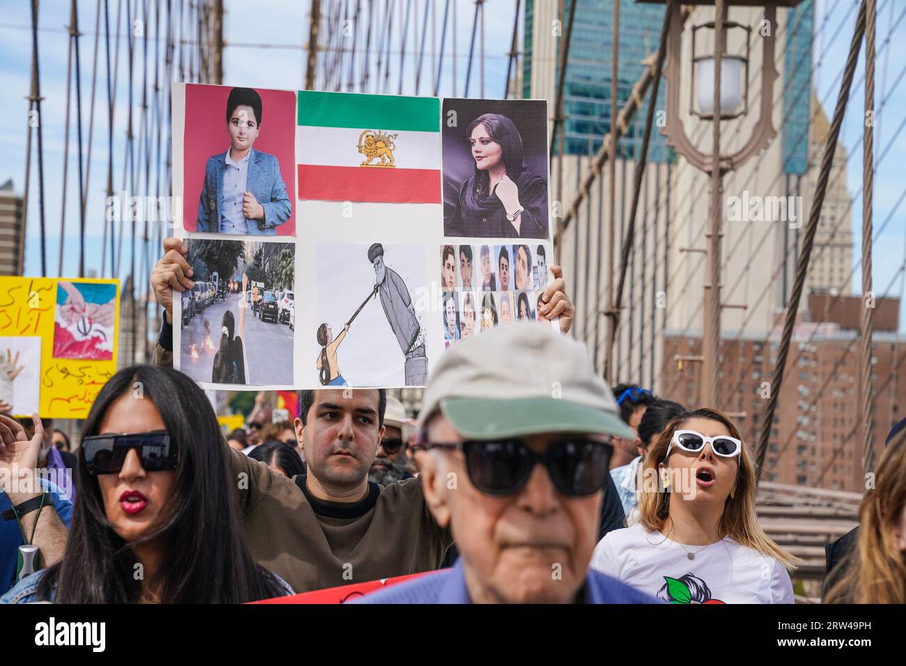 Hundreds of people rally and march across of Brooklyn Bridge in New York on September 16, 2023  on one year anniversary of murder of Mahsa Jina Amini in Iran after arest for allegedly not wearing the hijab Stock Photo