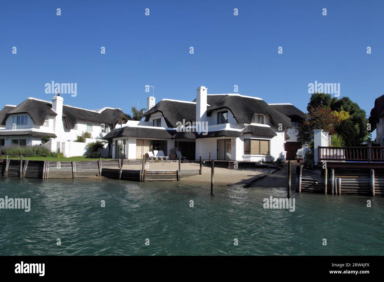 Typical houses with thatched roofs on the canals in St Francis Bay, South Africa. Typical houses
