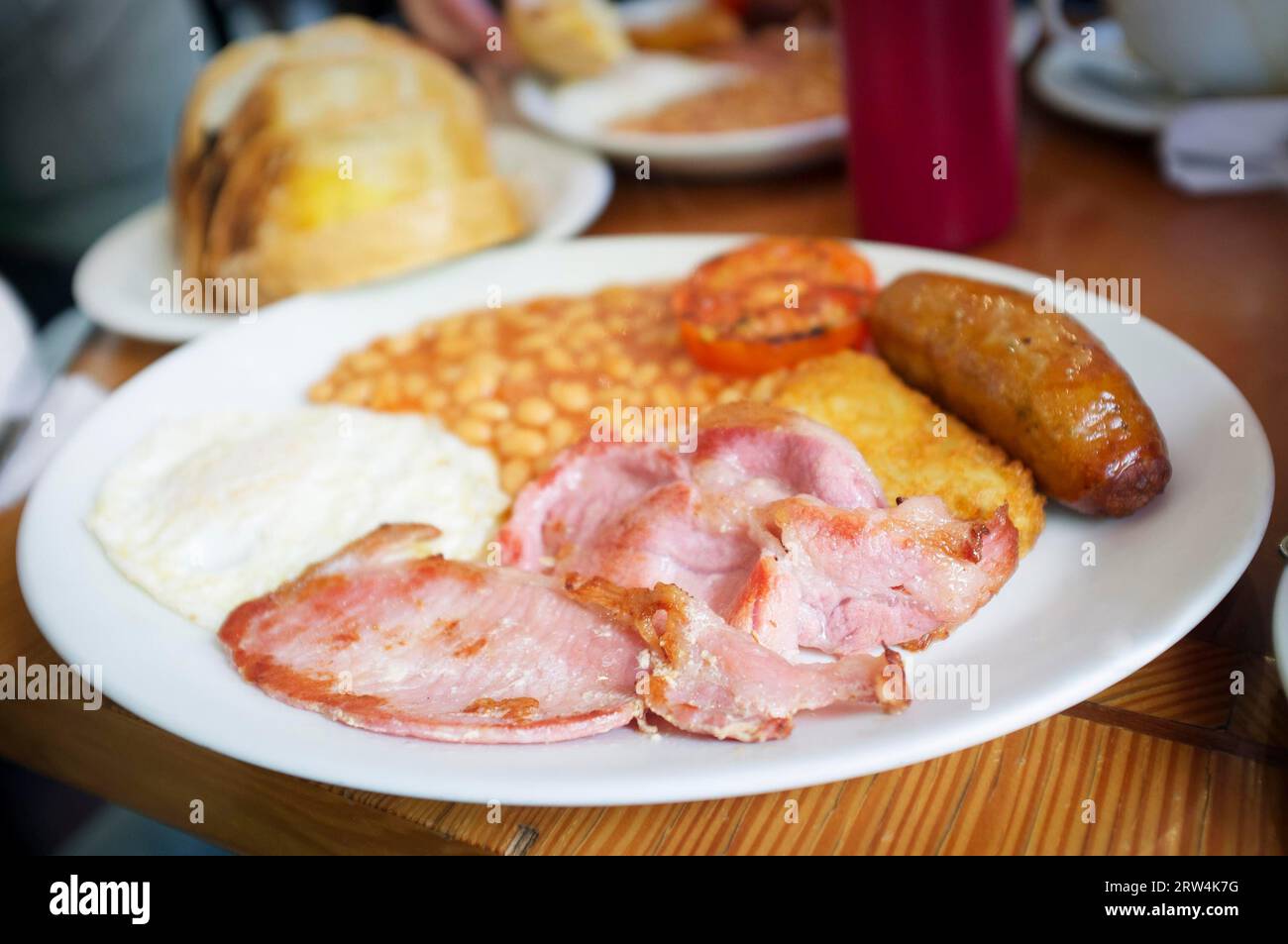 Traditional English breakfast, egg, bacon, sausage and beans served in