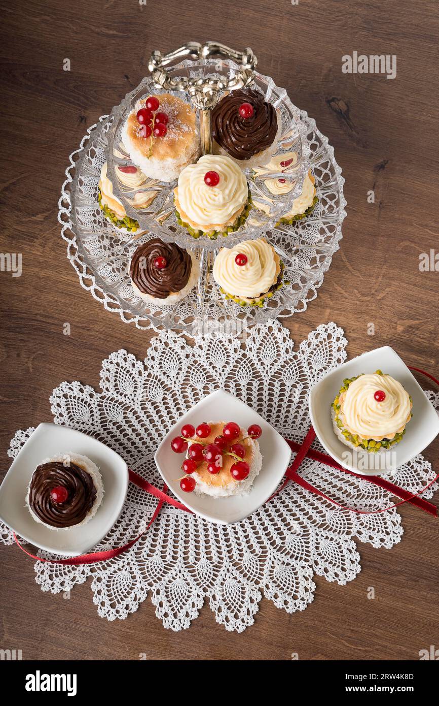 Cream tartlets with currants in small bowls and on an etagere Stock Photo