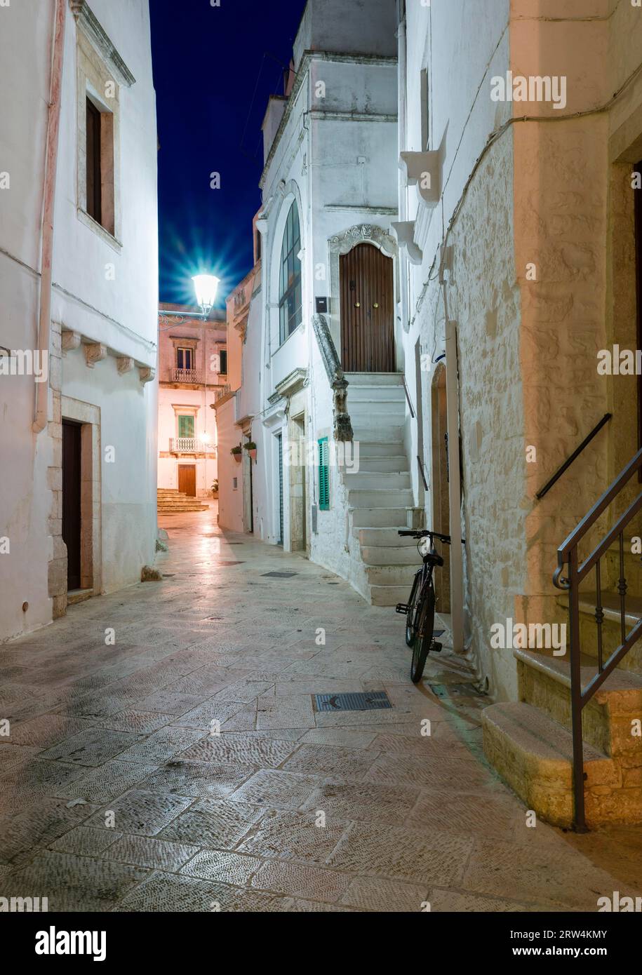 Blue hour, alley with bicycle, winegrowing town, Locorotondo, Valle d?Itria, Trullo Valley, Apulia, Puglia, Italy Stock Photo