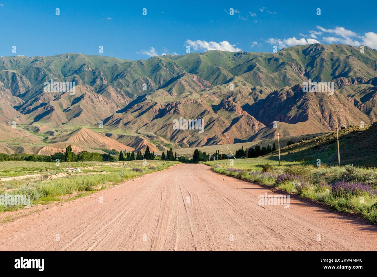Wide country road in Tien Shan mountains, Kyrgyzstan Stock Photo