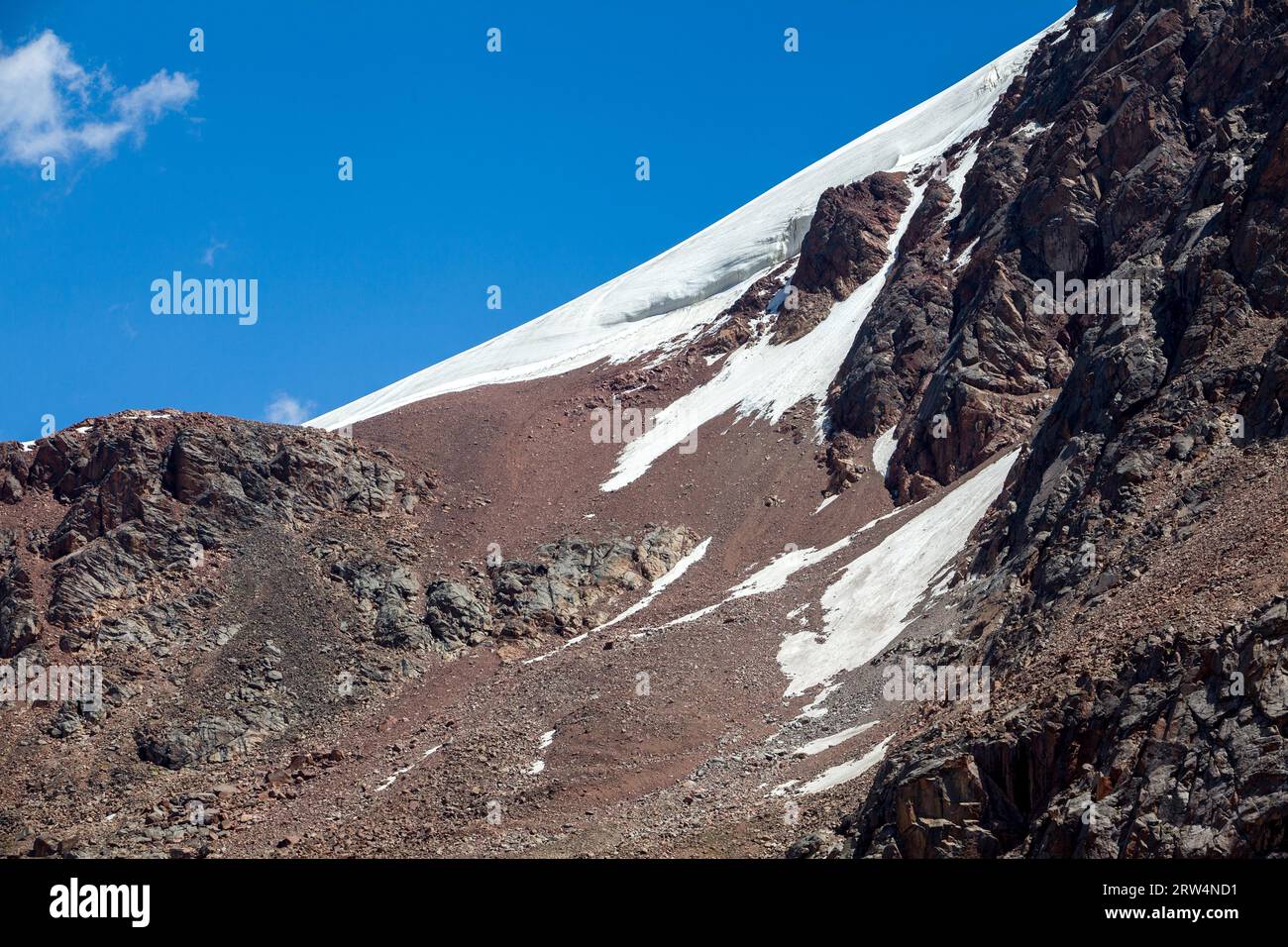 Snow slope of red mountain. Tien Shan, Kyrgyzstan Stock Photo