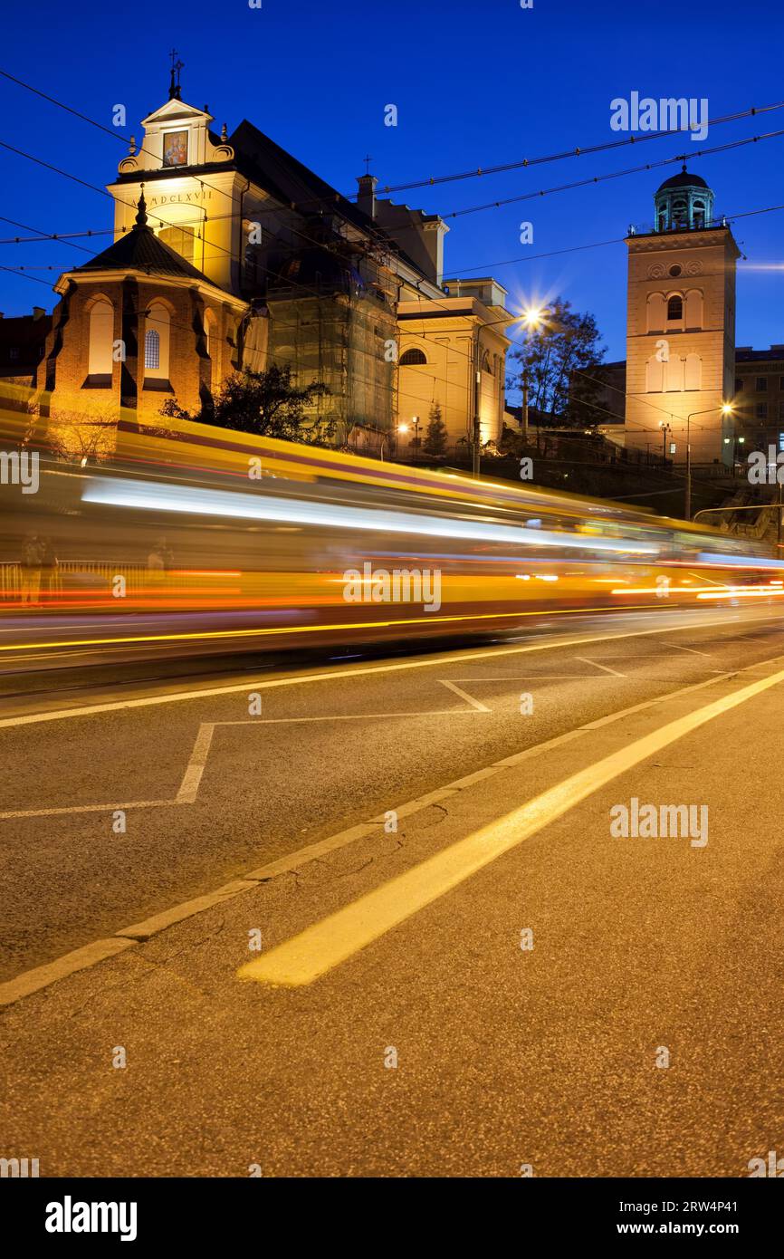 Night traffic on the Solidarity Avenue and illuminated St Anne Church in Warsaw, Poland Stock Photo