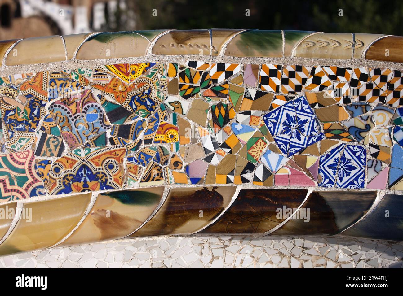 Trencadis abstract mosaic from broken tile shards, part of Serpentine Bench at Gaudi's Park Guell in Barcelona, Catalonia, Spain Stock Photo