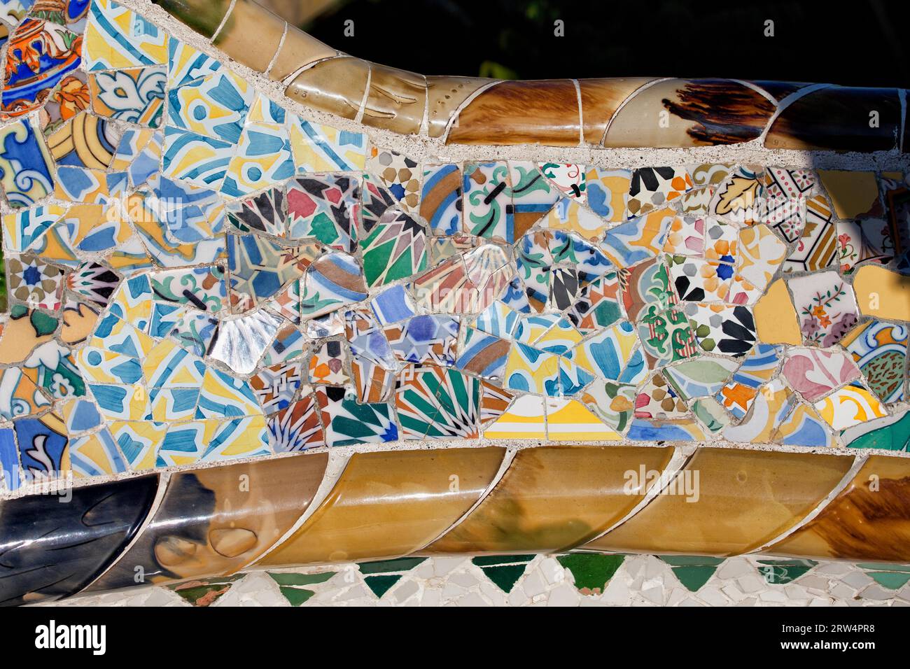 Trencadis abstract mosaic from broken tile shards, part of Serpentine Bench at Gaudi's Park Guell in Barcelona, Catalonia, Spain Stock Photo
