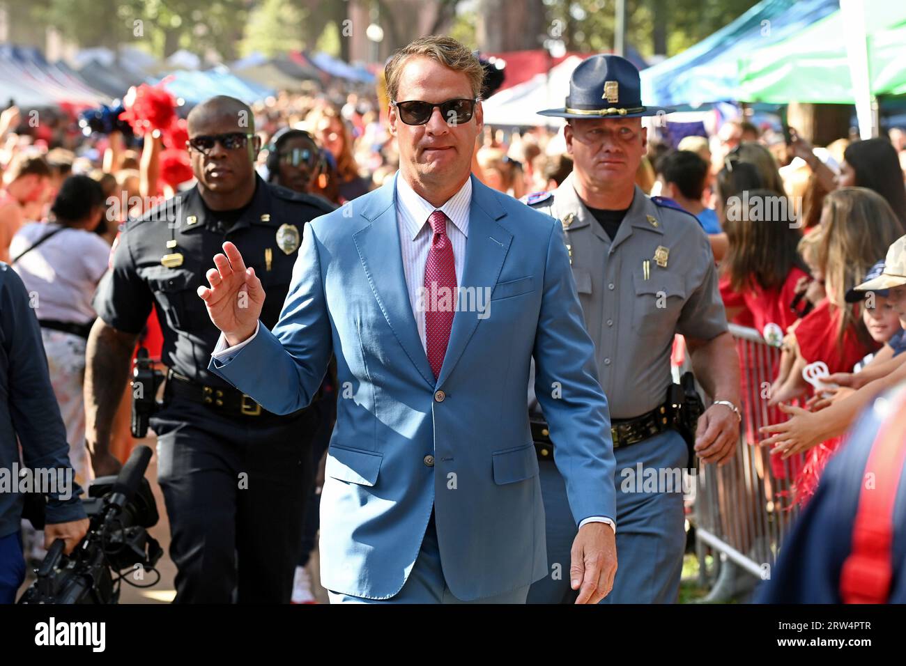 Mississippi head coach Lane Kiffin waves to fans during the Walk of