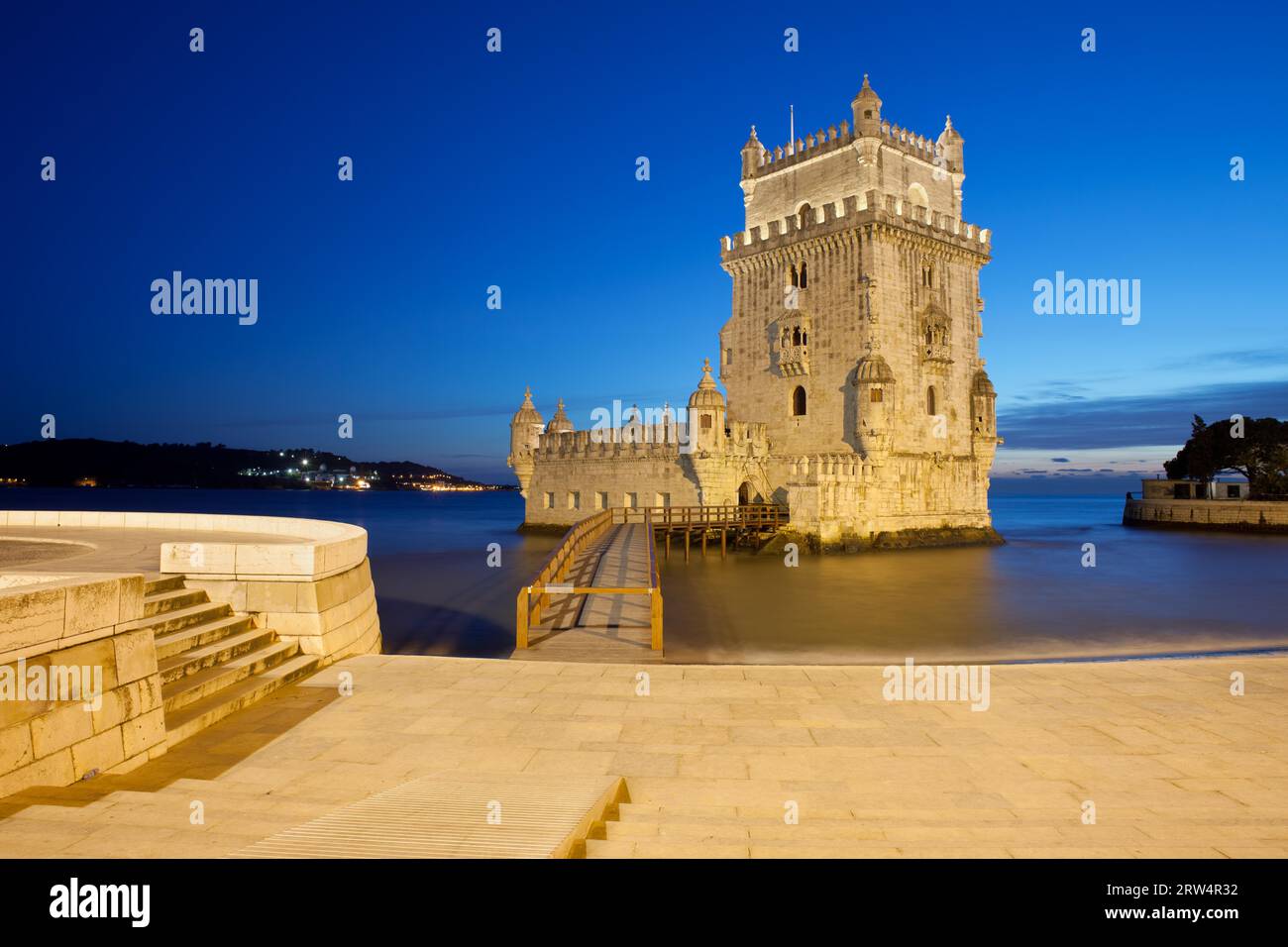 Belem Tower at night in Lisbon, Portugal, promenade along Tagus River Stock Photo