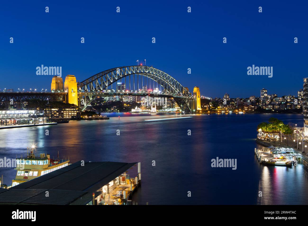 Boat traffic around Sydney harbour Bridge at rush hour on a winter's evening in Sydney, Australia Stock Photo