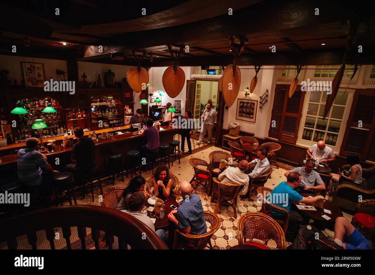 Singapore, Singapore, April 8th 2014: The famous Long Bar within the historic Raffles hotel on a warm evening in Singapore. Famous for the Singapore Stock Photo