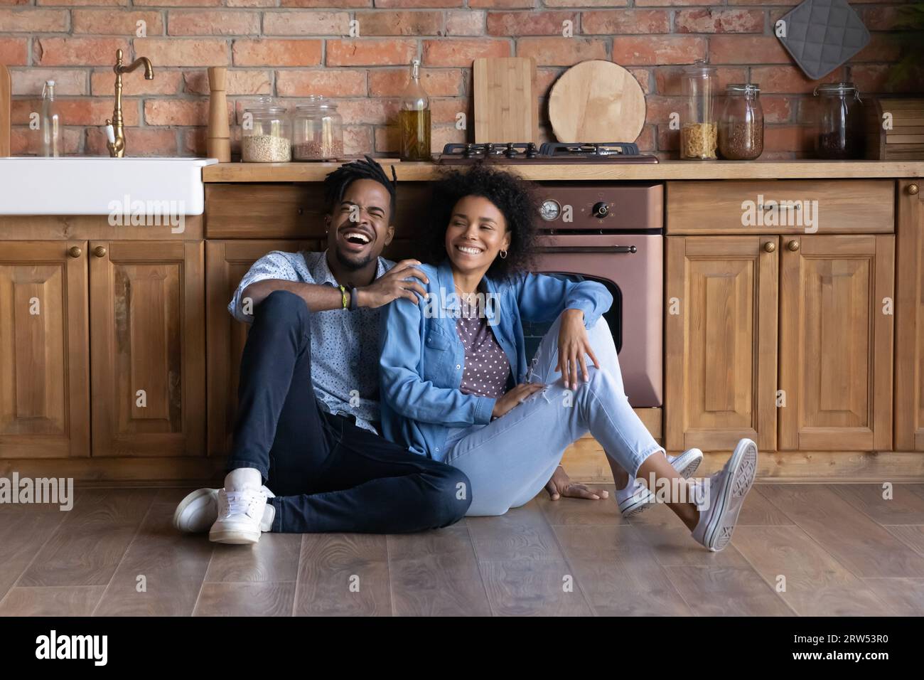Excited black couple sitting hi-res stock photography and images - Alamy