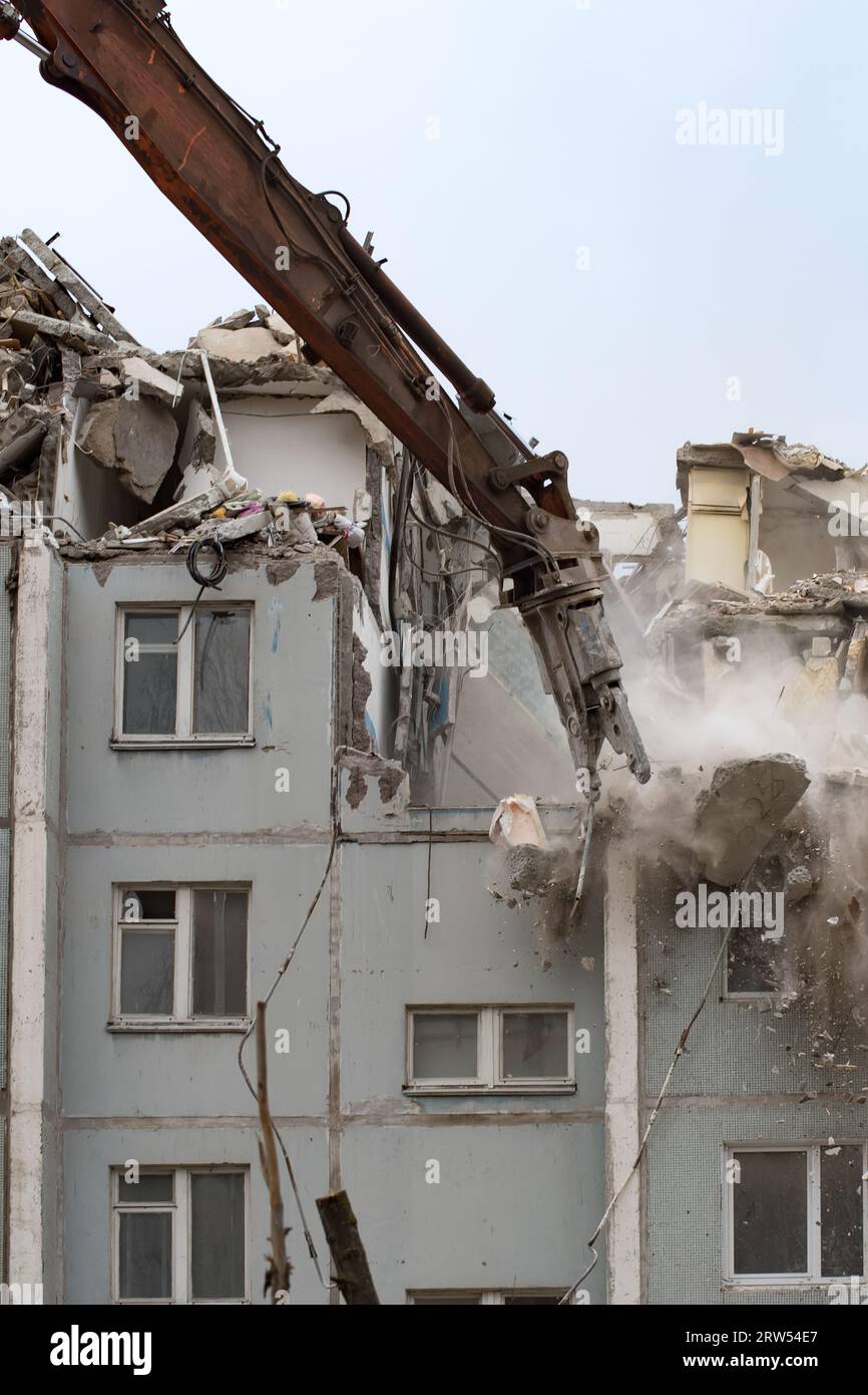 Demolition of a residential house using building hydraulic shears Stock