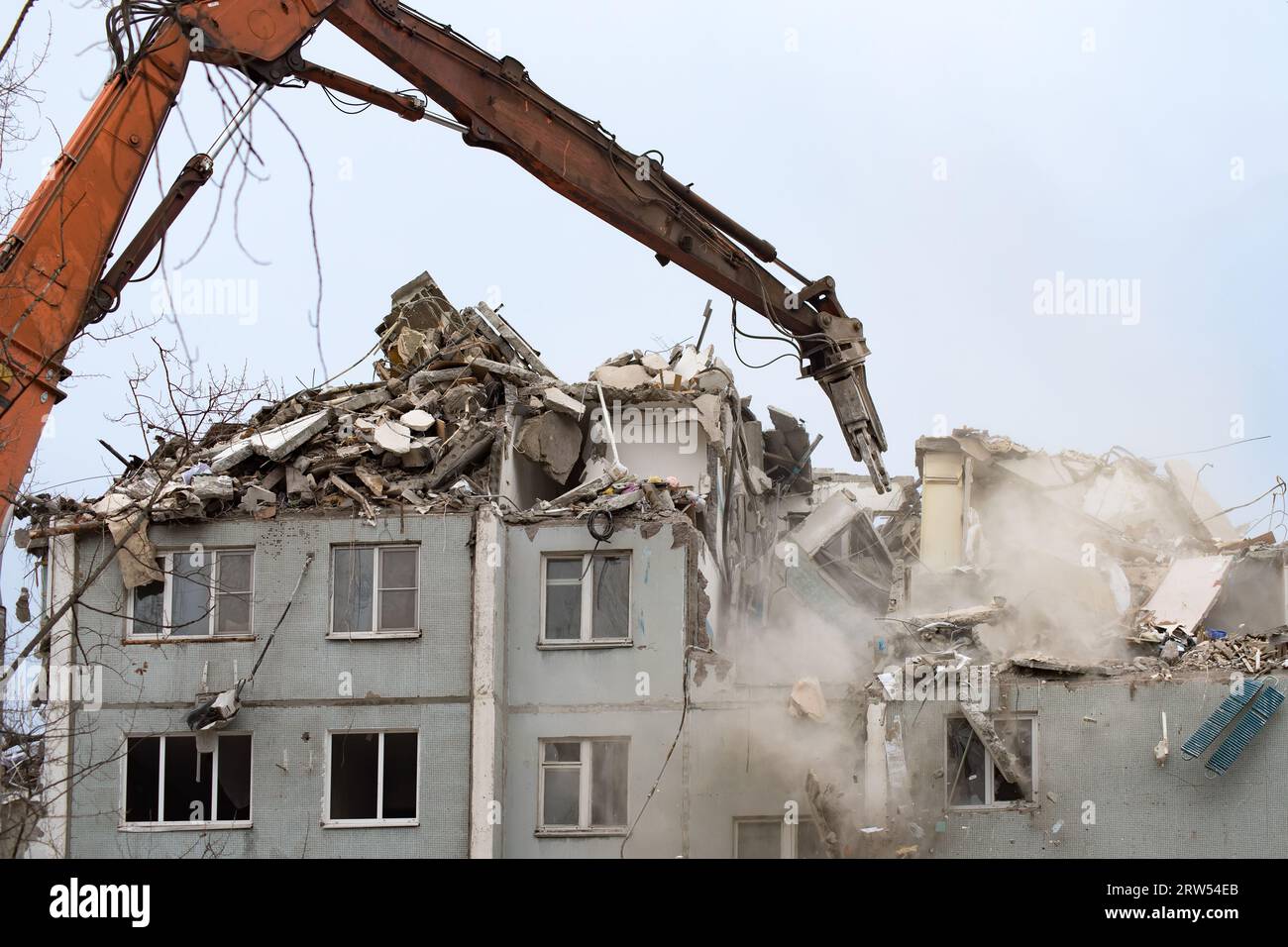 Demolition of a residential house using building hydraulic shears Stock