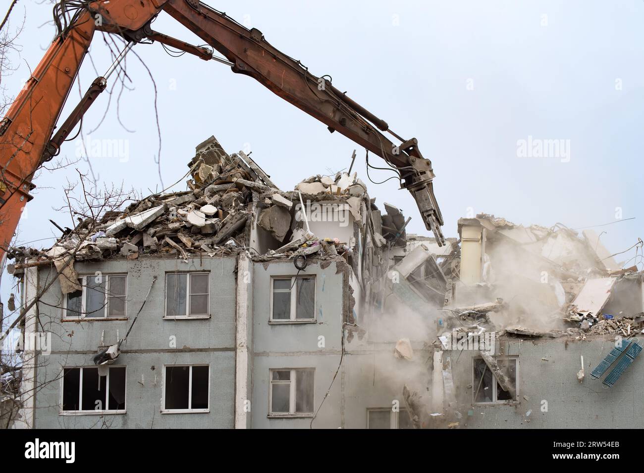 Demolition of a residential house using building hydraulic shears Stock Photo
