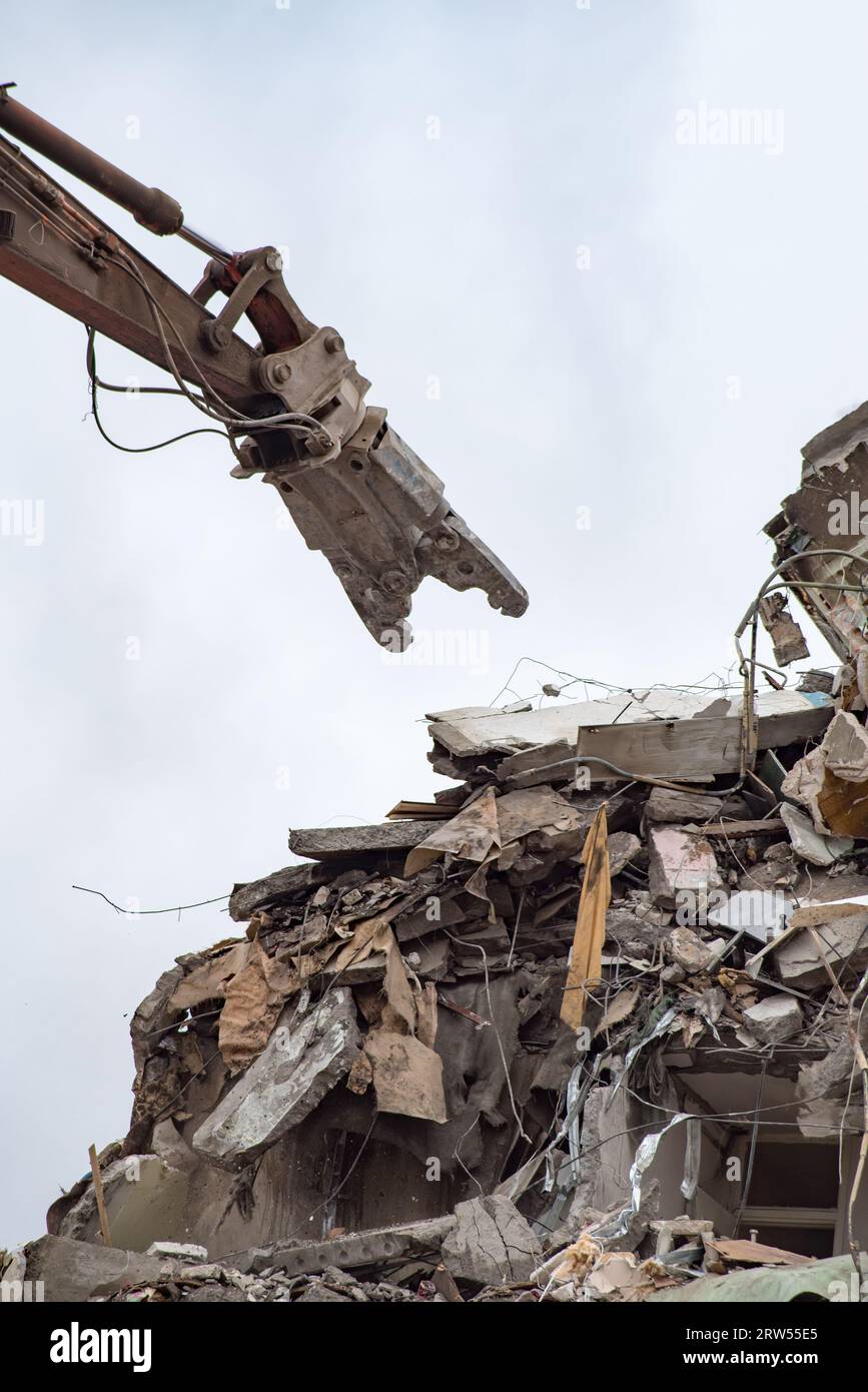 Demolition of a residential house using building hydraulic shears Stock