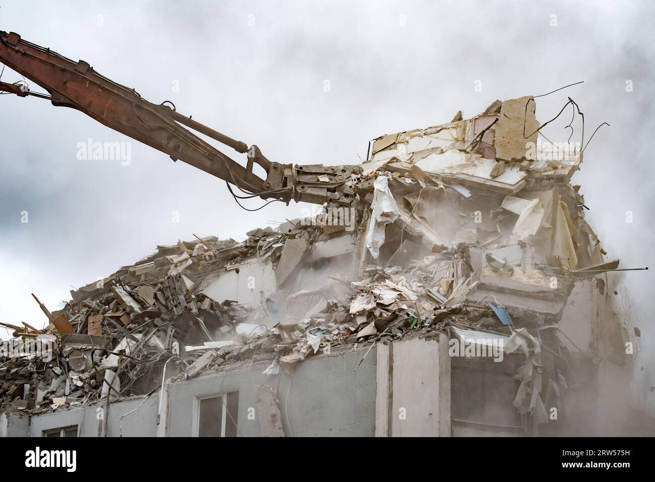Demolition of a residential house using building hydraulic shears Stock Photo
