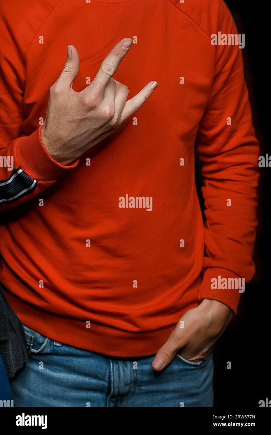 Gesture of a man's hand, close-up, sign and symbol of the rocker movement on black background. Stock Photo