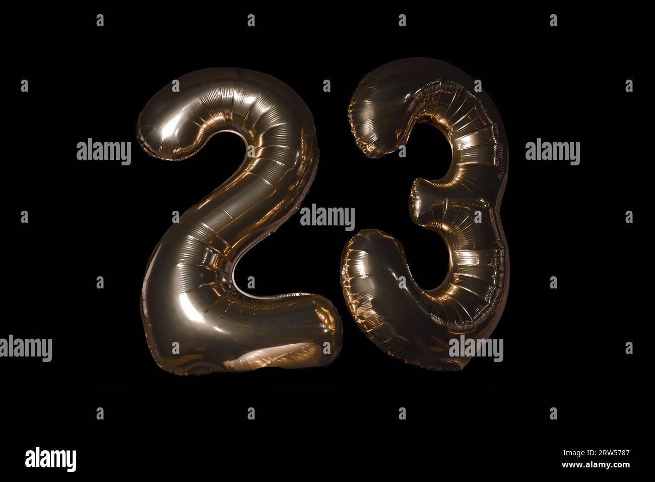 Number 2 two and 3 three 23 twenty-three digits inflated from a balloon air object on a black background. Stock Photo