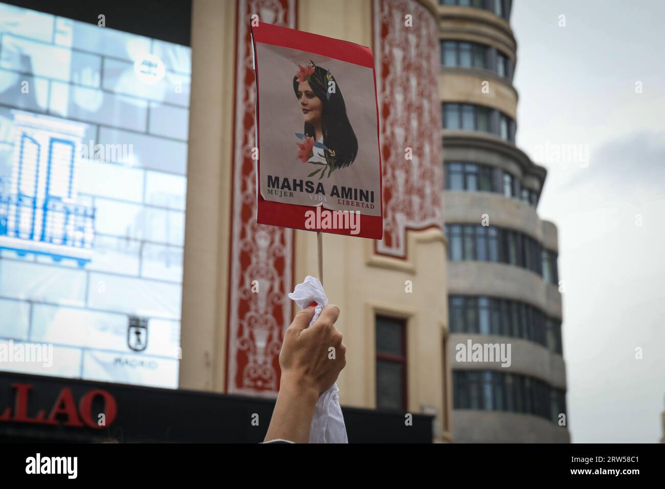 Madrid, Spain. 16th Sep, 2023. Iranian protester holds a placard with the face of Mahsa Amini during the demonstration. Iranian residents in Madrid have gathered in the Plaza de Callao to commemorate the first year of the death of the young Kurdish woman Mahsa Amini, who died after being detained by the Iranian morality police for not wearing the Islamic scarf properly and failed. Credit: SOPA Images Limited/Alamy Live News Stock Photo