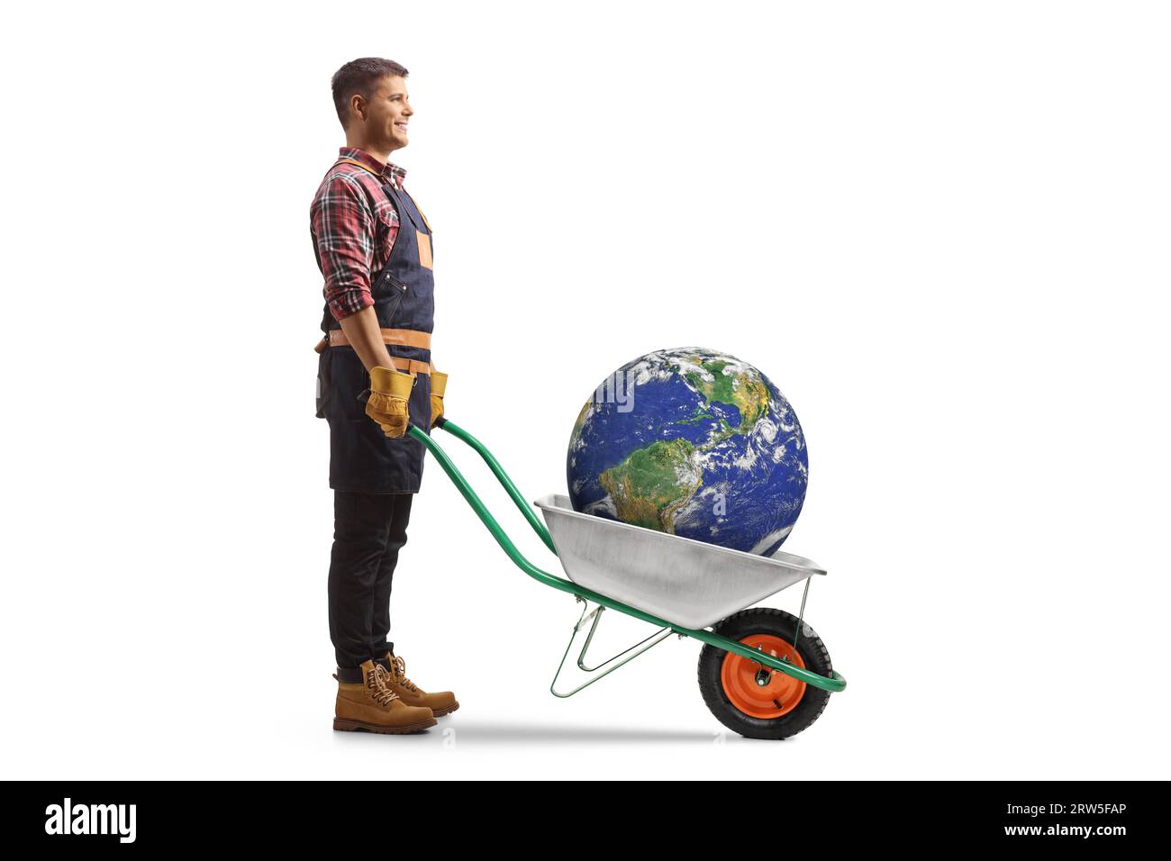 Farmer standing with the planet earth inside a wheelbarrow isolated on white background Stock Photo