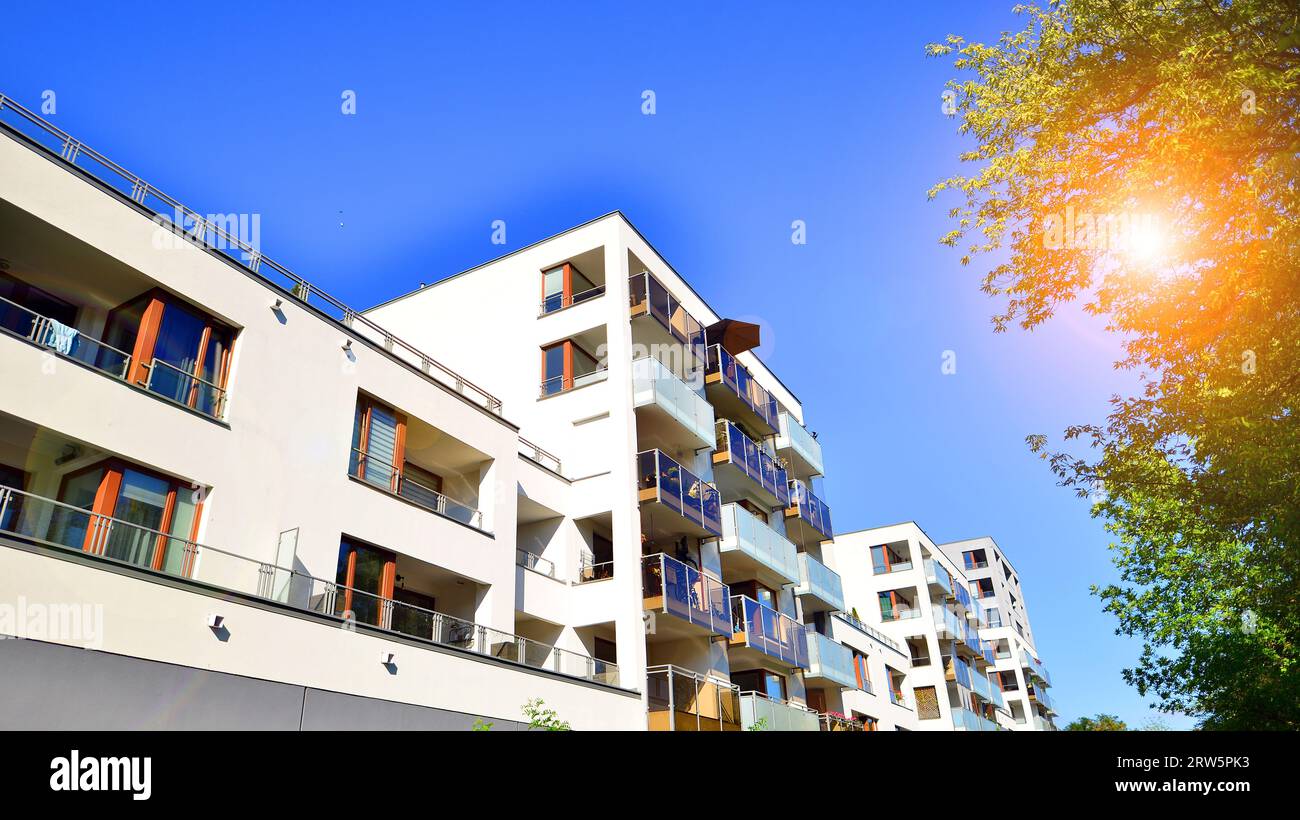 View of Modern apartment building and green trees. Ecological housing ...