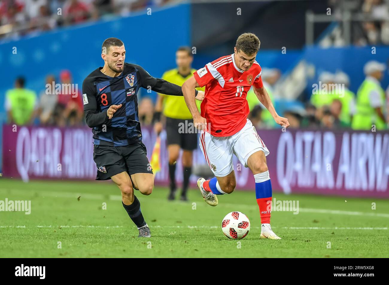 Sochi, Russia – July 7, 2018. Croatia national football team midfielder Mateo Kovacic and Russia midfielder Roman Zobnin during World Cup 2018 quarter Stock Photo