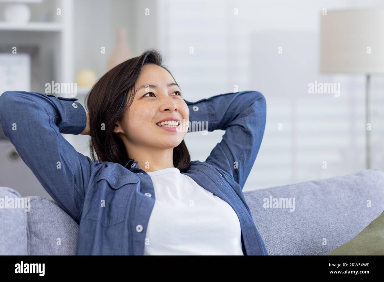 Closeup photo of a young beautiful Asian at home in the living room