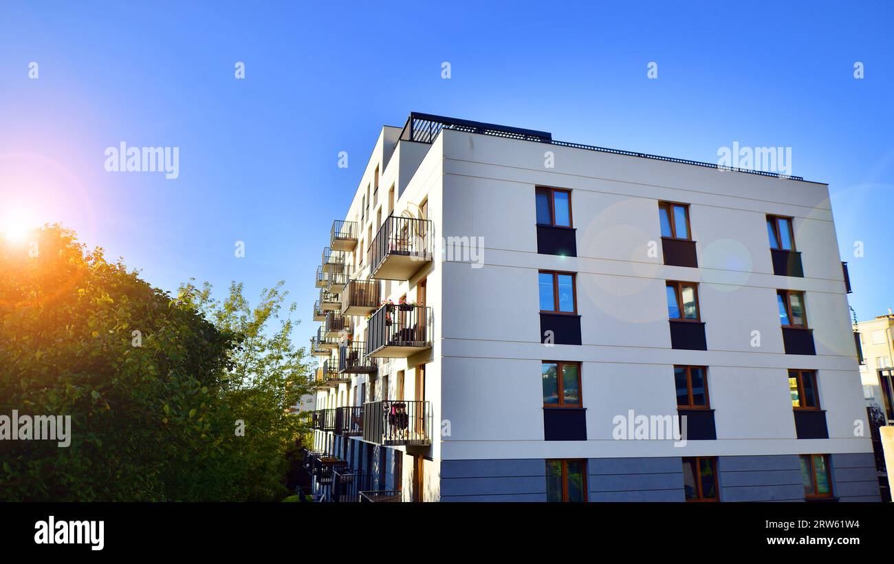 View of Modern apartment building and green trees. Ecological housing ...